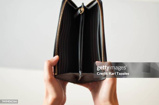 a woman is holding an empty wallet - leather purse open stock pictures, royalty-free photos & images