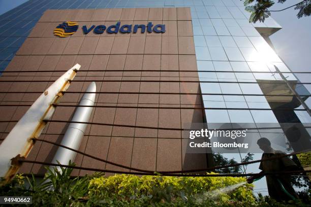 Man waters plants outside the Indian headquarters of Vedanta Resources Plc, which houses the company's Sterlite Industries Ltd. Unit, in Mumbai,...