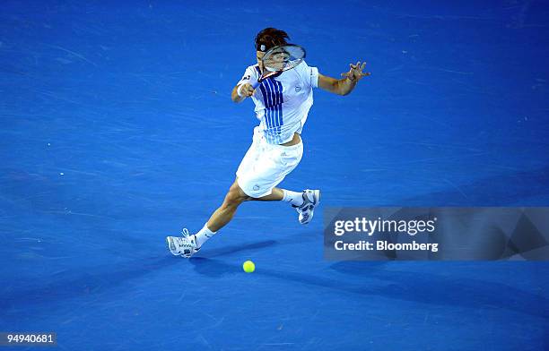 Tommy Haas of Germany returns the ball to Rafael Nadal of Spain during their match on day six of the Australian Open Tennis Championship, in...