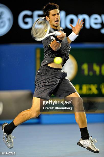 Novak Djokovic of Serbia returns the ball to Marcos Baghdatis of Cyprus during their match on day seven of the Australian Open Tennis Championship,...