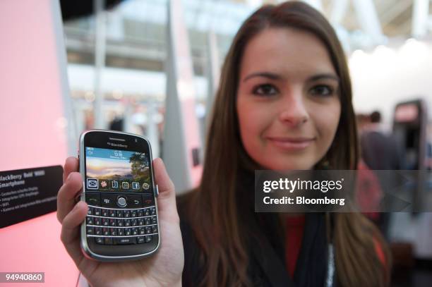 Anke Bursie holds a Blackberry Bold 9000 smartphone at CeBIT in Hannover, Germany, on Tuesday, March 3, 2009. Makers of software, computers and...