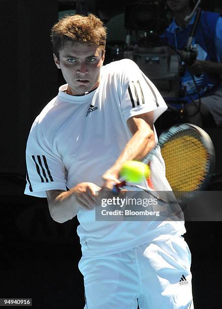 Gilles Simon of France returns the ball to Gael Monfils of France on day eight of the Australian Open Tennis Championship, in Melbourne, Australia,...