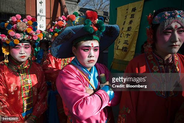Performers wait at the Ditan Temple Fair during celebrations for the Lunar New Year in Beijing, China, on Monday, Jan. 27, 2009. "With the approach...