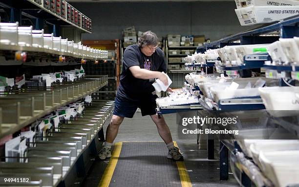 Postal worker Ray Jaeger sorts mail at the U.S. Postal Service Mid-Island Processing and Distribution Center in Melville, New York, U.S., on...