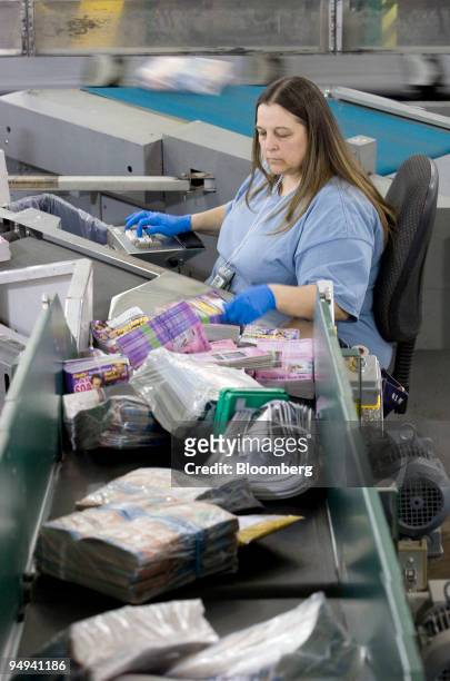 Postal worker Denise Lanier sorts mail by zip code before delivery at the U.S. Postal Service Mid-Island Processing and Distribution Center in...