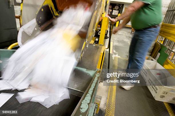Postal worker Bob Radu unloads incoming mail to be sorted at the U.S. Postal Service Mid-Island Processing and Distribution Center in Melville, New...