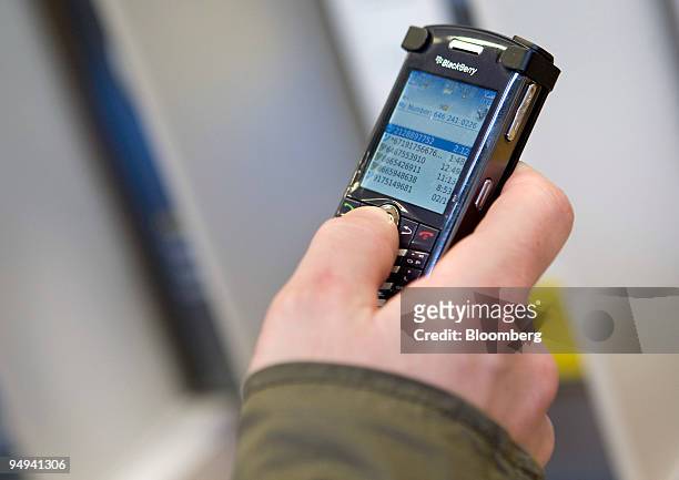 Jeff Matteuzzi tests out a Research In Motion RIM Blackberry at a Sprint Nextel Corp. Retail store in New York, U.S., on Thursday, Feb. 19, 2009....