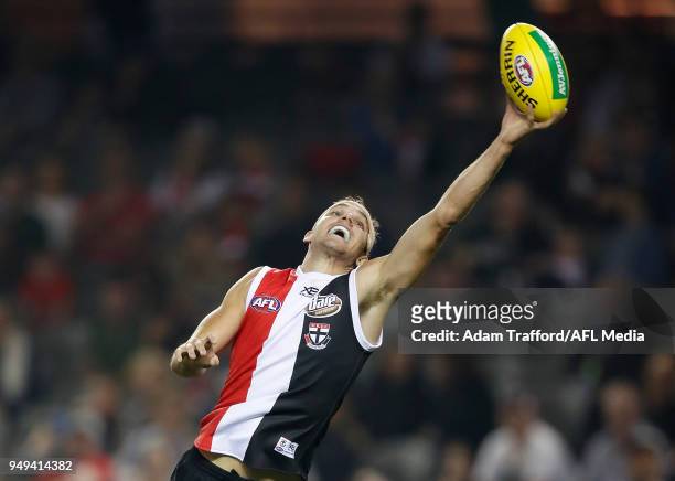 Brandon White of the Saints reaches for the ball during the 2018 AFL round five match between the St Kilda Saints and the GWS Giants at Etihad...