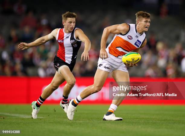 Adam Tomlinson of the Giants in action ahead of Jack Billings of the Saints during the 2018 AFL round five match between the St Kilda Saints and the...