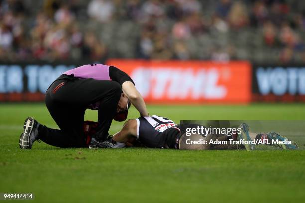 Jack Newnes of the Saints lays on the field after a clash with Dawson Simpson of the Giants during the 2018 AFL round five match between the St Kilda...