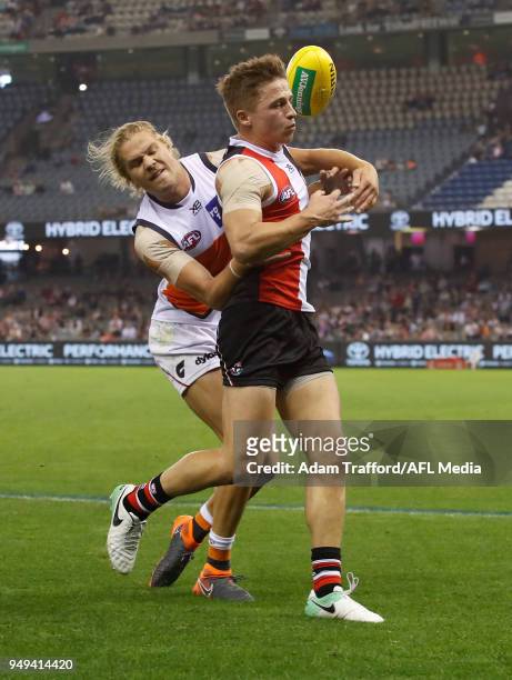 Jack Billings of the Saints is tackled by Harry Himmelberg of the Giants during the 2018 AFL round five match between the St Kilda Saints and the GWS...
