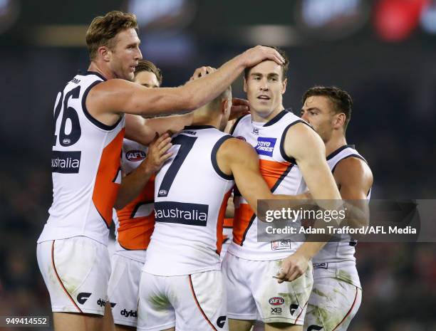 Dawson Simpson and Jeremy Cameron of the Giants dcongratulate Brett Deledio of the Giants on a goal uring the 2018 AFL round five match between the...