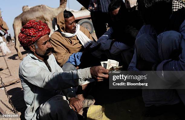 Traders do business at the Naguar Camel Fair, in Naguar, India, on Monday, Feb. 2, 2009. Asia's third-largest economy will probably expand 7.1...