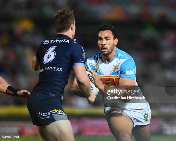 Ryan James of the Titans looks to get past Michael Morgan of the Cowboys during the round seven NRL match between the North Queensland Cowboys and...