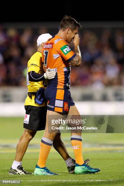Mitchell Pearce of the Knights leaves the field during the round seven NRL match between the Wests Tigers and the Newcastle Knights at Scully Park on...