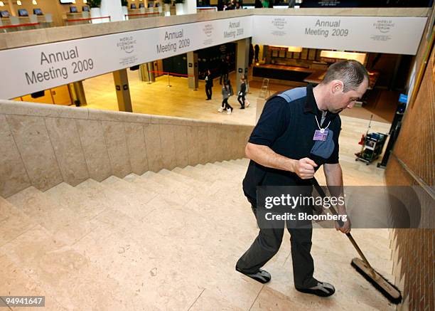 Employee Manuel Jaeger sweeps the main stairway in the Congress Center at the World Economic Forum prior to the meeting in Davos, Switzerland, on...