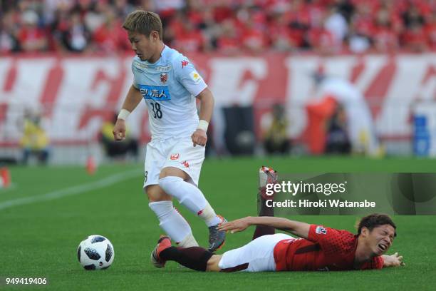 Daiki Suga Consadole Sapporo and Kazuki Nagasawa of Urawa Red Diamonds compete for the ball during the J.League J1 match between Urawa Red Diamonds...