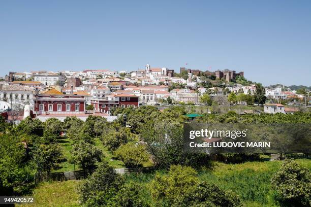 The castle and cathedral are pictured ontop of the old town of Silves on April 18, 2018 in the southern Portugal region of Algarve.