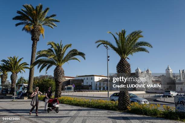 People walk in the old city center of Silves on April 18, 2018 in the southern Portugal region of Algarve.