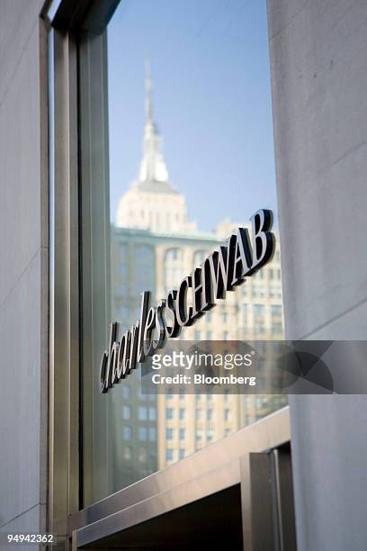 The company logo hangs in the window of a Charles Schwab branch in New York, U.S., on Tuesday, Feb. 24, 2009. Charles Schwab Corp. And other 401...