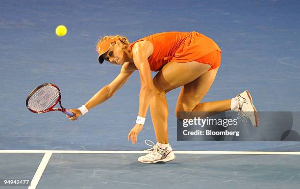 Elena Dementieva of Russia returns the ball to Serena Williams of the United States during their match on day 11 of the Australian Open Tennis...
