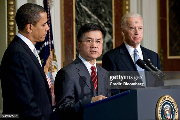 Gary Locke, former governor of Washington, center, is flanked by U.S. President Barack Obama, left, and Vice President Joseph Biden, right, as he...