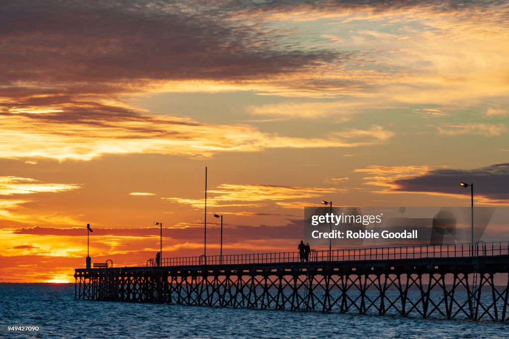 Silhouetted people walking along Jetty at Sunset - Ceduna, South Australia