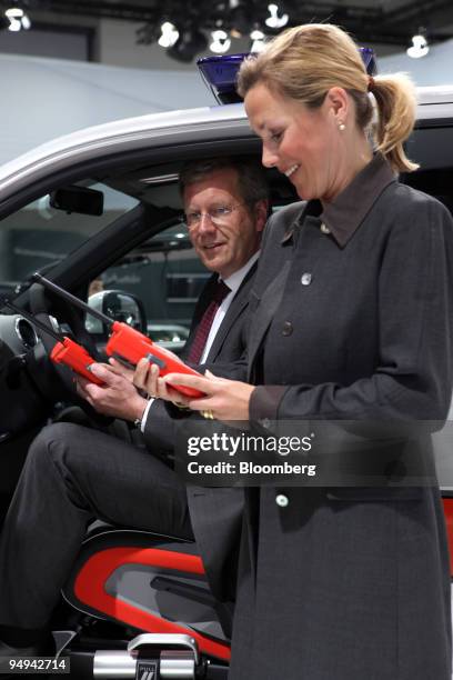 Christian Wulff, prime minister of the German state of Lower Saxony, which holds a 20 percent stake in Volkswagen AG, left, and his wife Bettina...