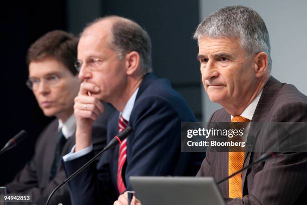 Juergen Hambrecht, chief executive officer of BASF SE, right, sits with Kurt Bock, chief financial officer, center, and Hans-Ulrich Engel, a member...