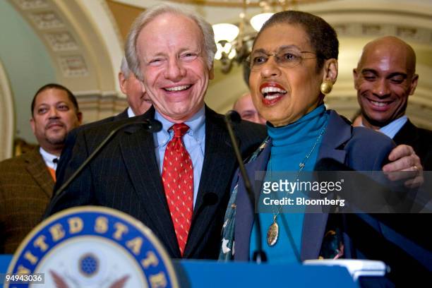 Senator Joe Lieberman, an independent from Connecticut, left, embraces Eleanor Holmes Norton, a D.C. Delegate, during a press conference after the...