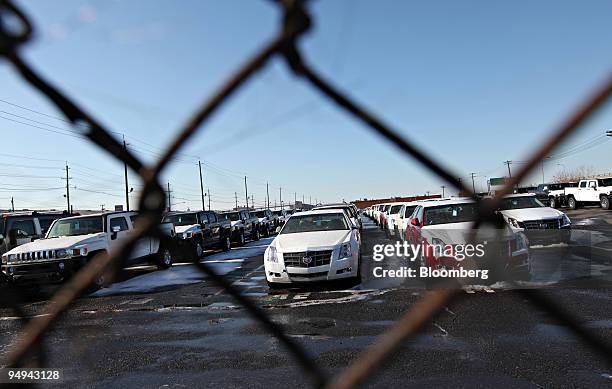 General Motors Co. Cadillac and Hummer H3 vehicles sit parked in a storage lot at the Port of Newark in Newark, New Jersey, U.S., on Thursday, Jan....