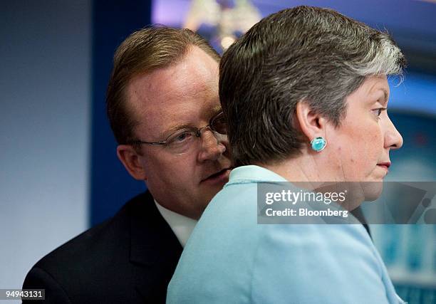 Janet Napolitano, secretary of the Department of Homeland Security, right, listens to Richard Gibbs, White House press secretary, during a press...