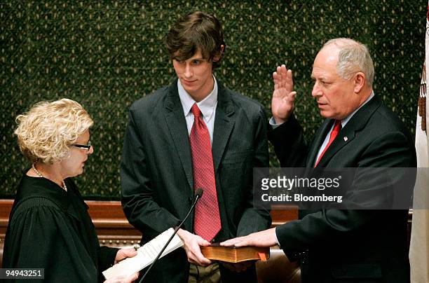 Lieutenant Governor Pat Quinn, right, is sworn in as the new governor of Illinois by Appellate court judge Anne Burke, left, while his son Pat Quinn...