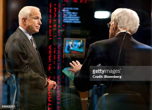 John McCain, Republican Senator from Arizona, left, speaks during an interview with Al Hunt, executive editor for Bloomberg News in Washington, D.C.,...
