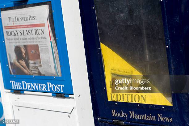 Issues of the Denver Post sit in a newspaper honor box next to an empty Rocky Mountain News box in Denver, Colorado, U.S., on Friday, Feb. 27, 2009....