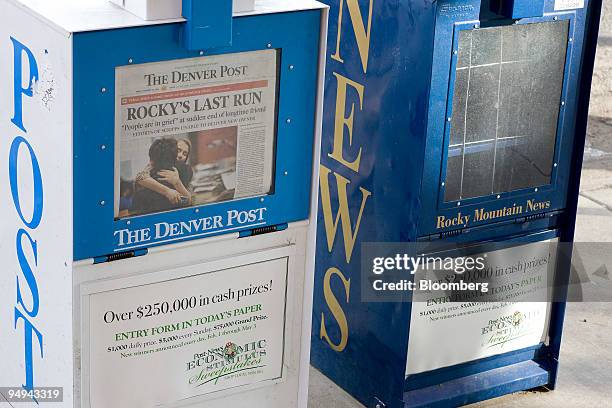 Issues of the Denver Post sit in a newspaper honor box next to an empty Rocky Mountain News box in Denver, Colorado, U.S., on Friday, Feb. 27, 2009....