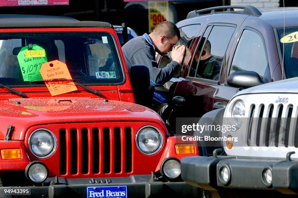 Customer looks at previously owned Chrysler Jeep sport utility vehicles on the Fred Beans dealership lot in Doylestown, Pennsylvania, U.S., on...