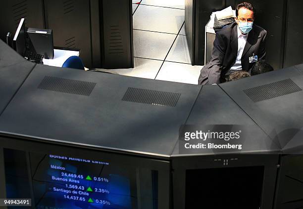Trader wearing a surgical mask works on the floor of the Mexican Stock Exchange, or Bolsa Mexicana de Valores , in Mexico City, Mexico, on Wednesday,...