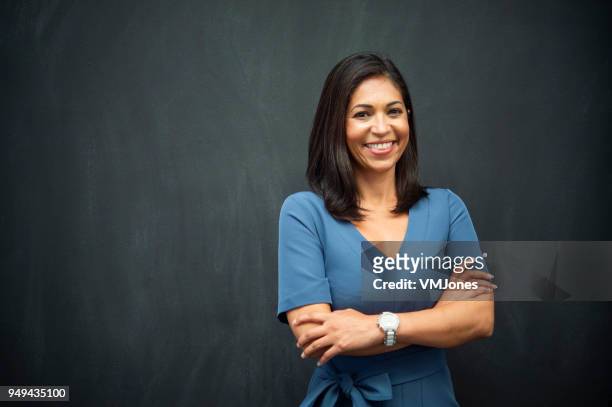 strong hispanic woman teacher - smart casual stock pictures, royalty-free photos & images