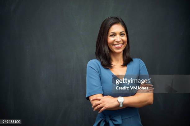 strong hispanic woman teacher - business woman portrait studio stock pictures, royalty-free photos & images