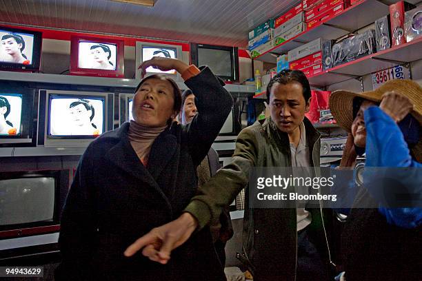 Residents of rural China shop for televisions and dvd players at the Shijihualiangouwu Market in Chenggong, Yunnan province, China, on Wednesday,...