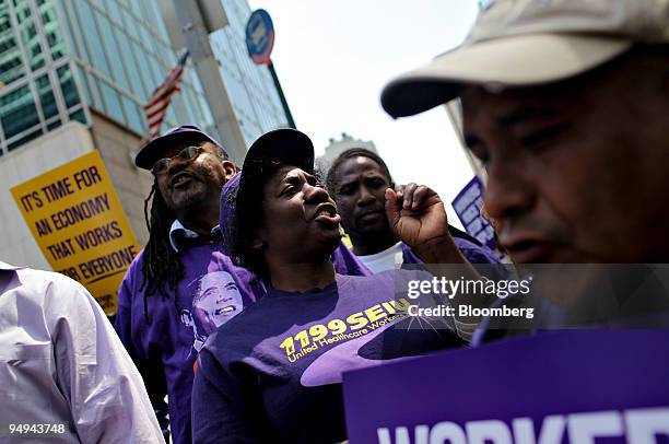 Winsome Batten, a member of the Service Employees International Union , center, demonstrates outside Bank of America Tower in New York, U.S., on...