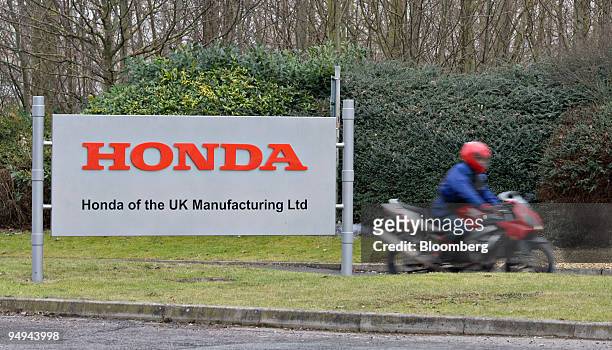 Motorcyclist leaves the Honda Motor Co. Car production plant at the end of a shift in Swindon, U.K., on Friday, Jan. 30, 2009. Honda, the world's...