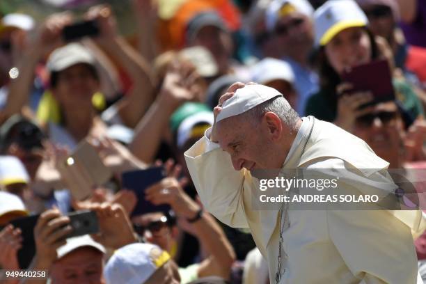 Pope Francis adjusts his zucchetto cap during his arrival for an audience with the Bologna and Cesena dioceses on April 21, 2018 at St Peter's Square...