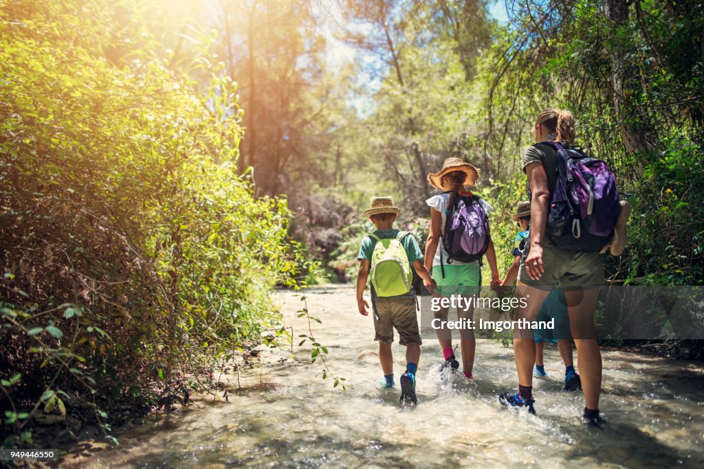 Mother and kids hiking in Andalusia river of Rio Chillar