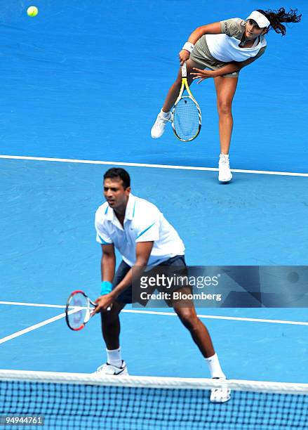 Sania Mirza of India and Mahesh Bhupathi of India serve the ball to Andy Ram of Israel and Nathalie Dechy of France in the mixed doubles final on day...