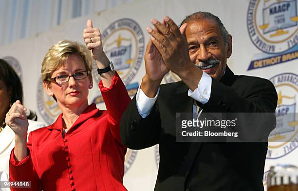 Jennifer Granholm, governor of Michigan, left, and John Conyers, a Democratic representative from Michigan, applaud during the NAACP 54th Annual...