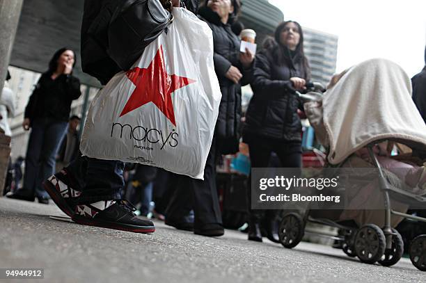 Niema Jack holds a Macy's bag outside Macy's department store in New York, U.S., on Monday, Feb. 2, 2009. Macy's Inc., the second-largest U.S....