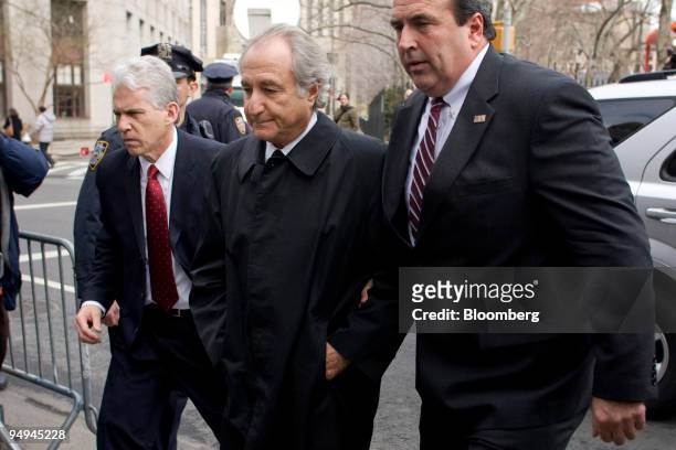 Bernard Madoff, founder of Bernard L. Madoff Investment Securities LLC, center, is escorted into Federal court in New York, U.S., on Tuesday, March...