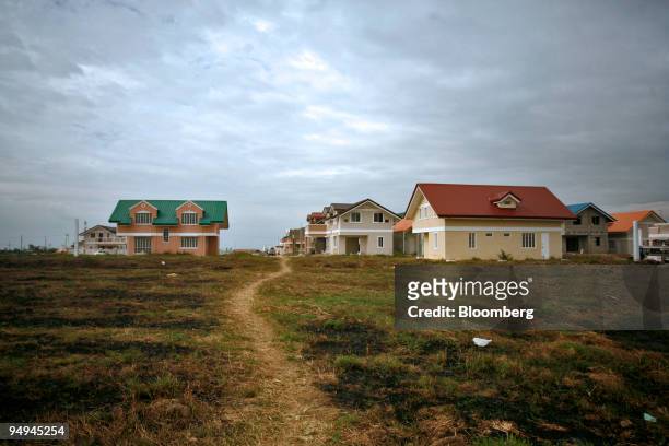Empty houses stand in a residential subdivision near the Intel Corp. Plant in the municipality of General Trias in Cavite province, the Philippines,...